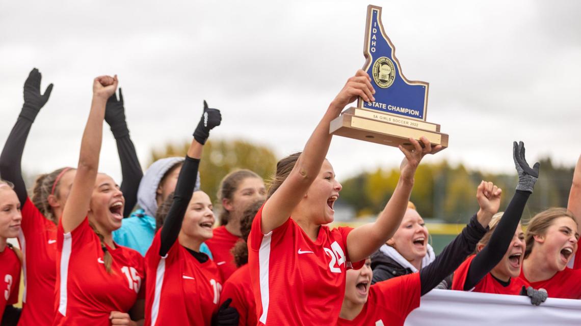 Annie Liebich hoists the 5A state championship trophy after the Boise girls soccer team beat Centennial 2-0 on Saturday at Bonneville High in Idaho Falls.