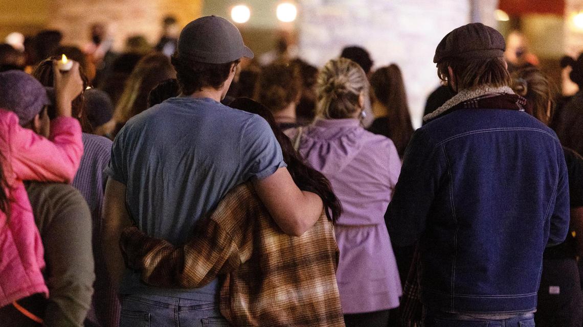 Two people embrace during a community vigil to honor Jo Acker and Roberto Padilla Arguelles, who died in Monday’s shooting at the shopping center, as well as survivors of the event.
