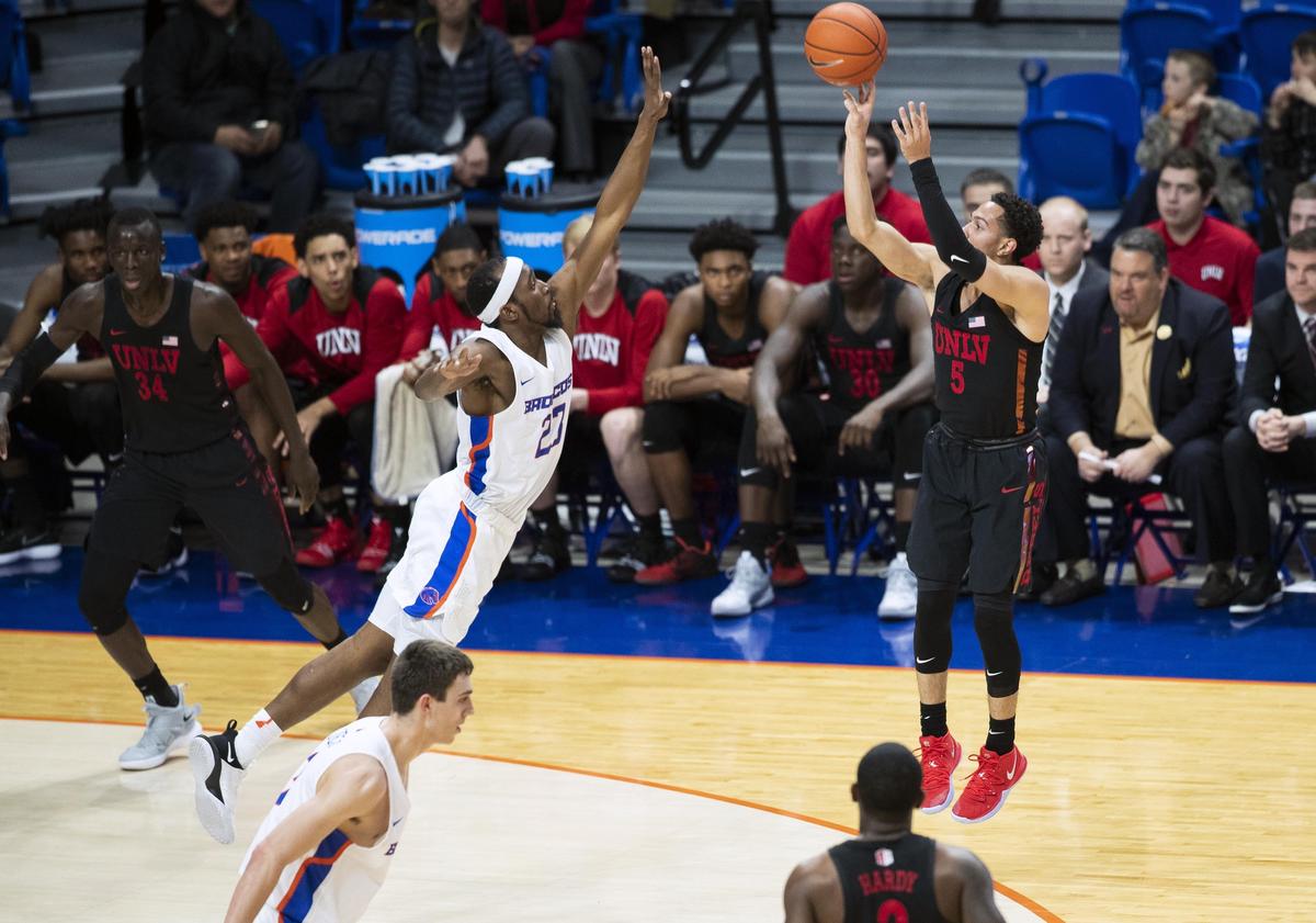 UNLV guard Noah Robotham pulls up for a 3-pointer defended by Boise State’s RJ Williams in the second half of the Rebels’ 83-72 victory over the Broncos Wednesday, Feb. 6, 2019 at Taco Bell Arena in Boise.