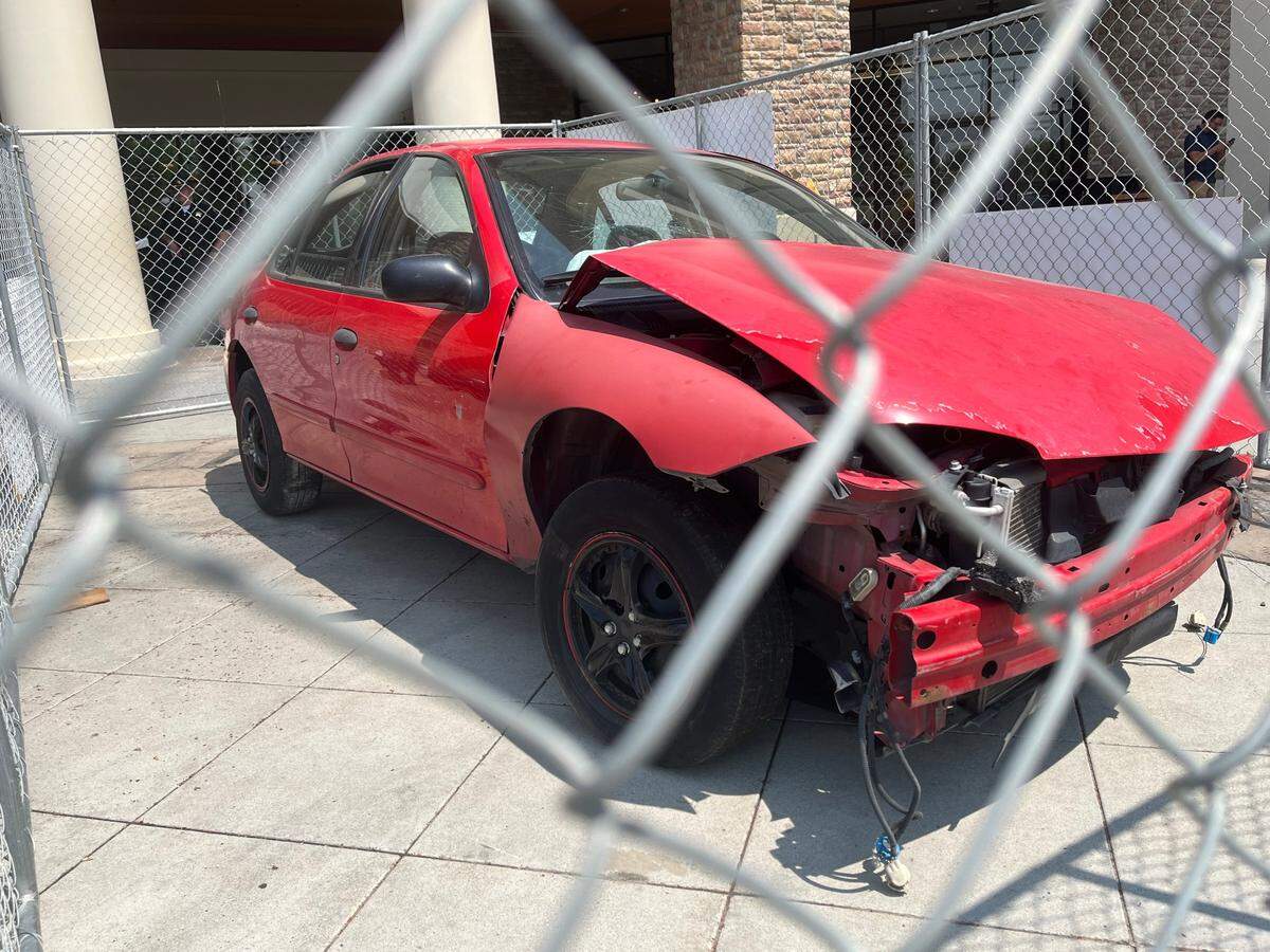 The 2003 Chevy Cavalier involved in a single-vehicle crash on the I-184 Connector. The driver was driving aggressively before crashing into the center median wall and coming to a halt.