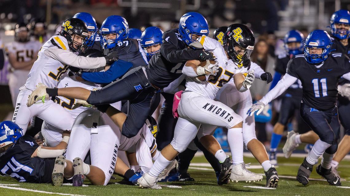 Bishop Kelly senior running back Tylan Kaschmitter carries the ball as Emmett linebacker sophomore Jax Banuelos tries to tackle him in the fourth quarter of their game Friday in Emmett. BK won 21-6.