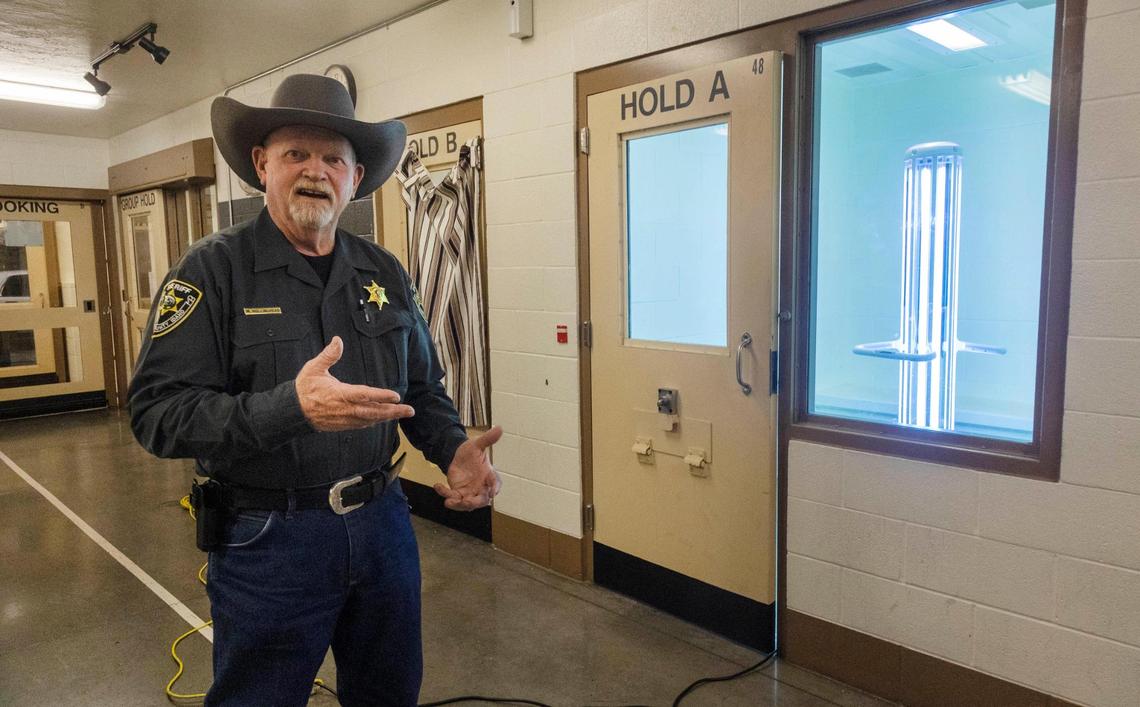 Elmore County Sheriff Mike Hollinshead says their sanitation policies have stopped COVID-19 outbreaks within staff and inmate populations. At right, a UV-C machine called the R-Zero Arc zaps an inmate booking area.