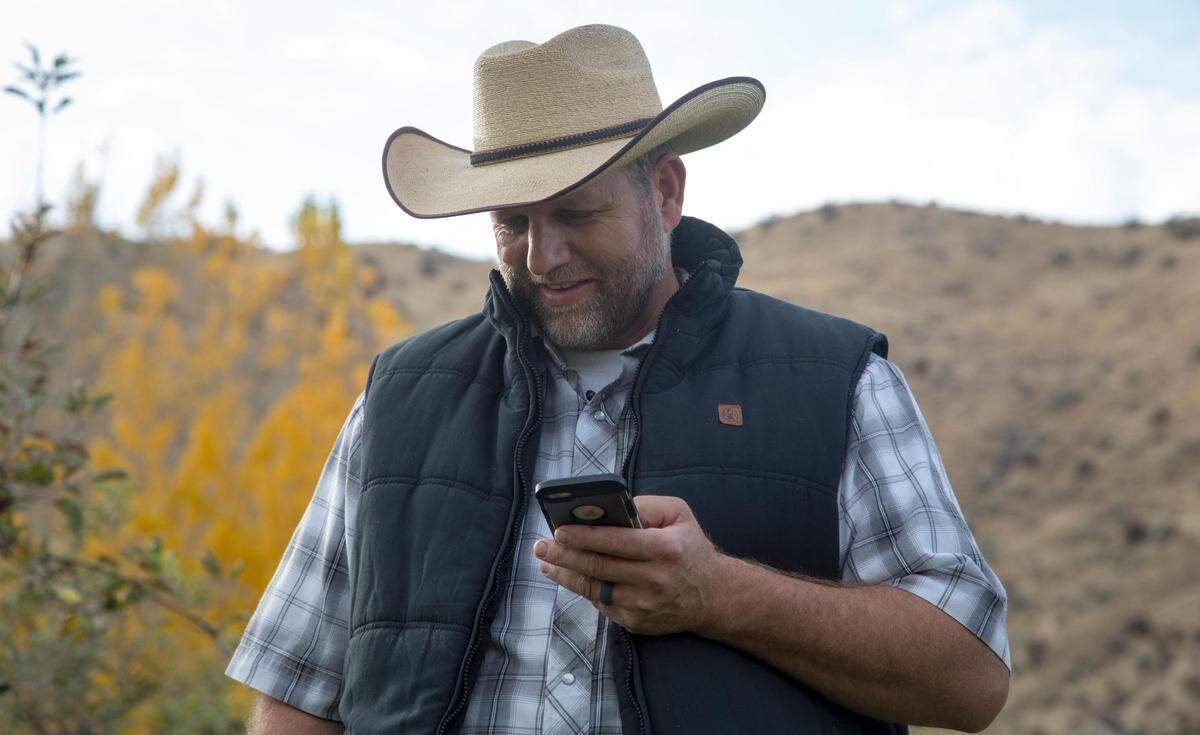 Ammon Bundy receives a call from a former fellow inmate while picking Gypsy Lust apples in his orchard.