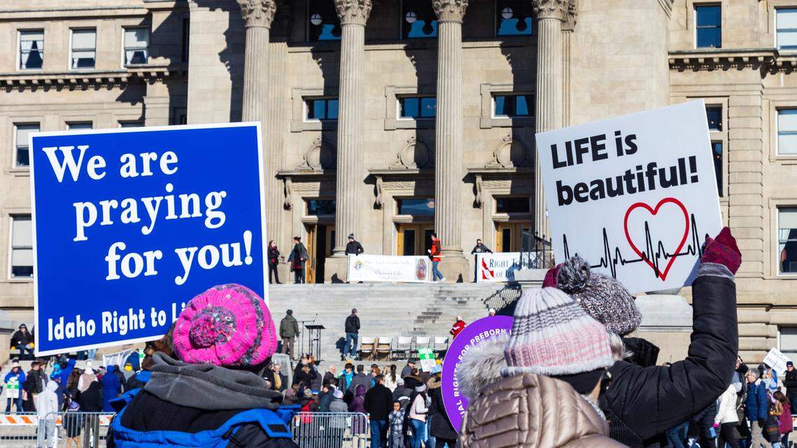 Demonstrators walk to the Idaho Capitol Building carrying anti-abortion signs for the Boise March for Life rally in 2023. Republican Idaho Gov. Brad Little on Wednesday signed House Bill 242, which prohibits traveling with a minor to another state for an abortion or helping a minor obtain an abortion-inducing drug.