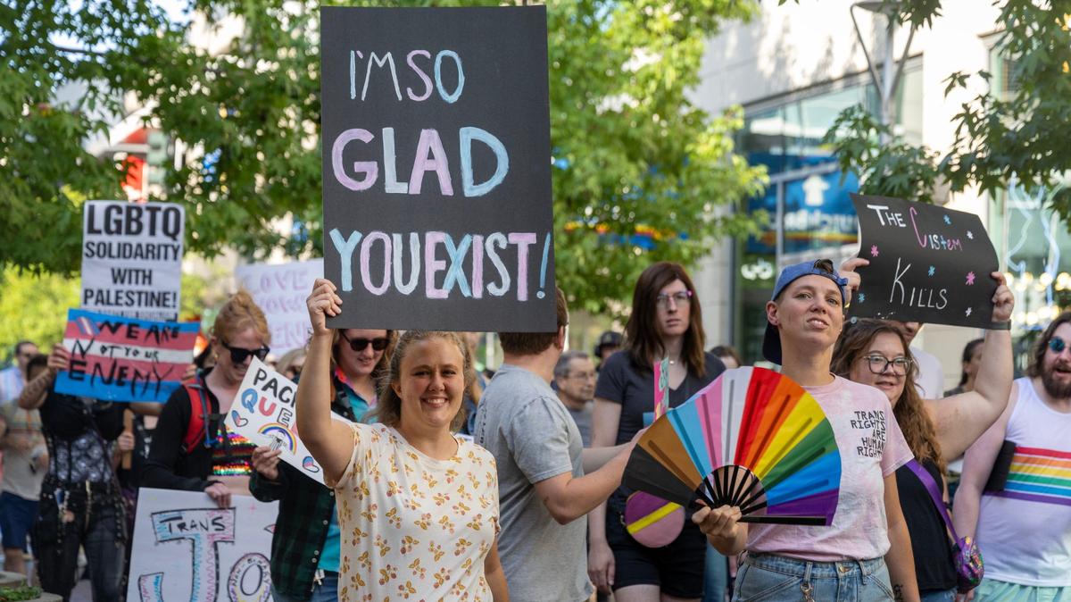 Demonstrators carry signs and flags in support of transgender people during the Trans March in Boise, Friday, Sept. 13, 2024.