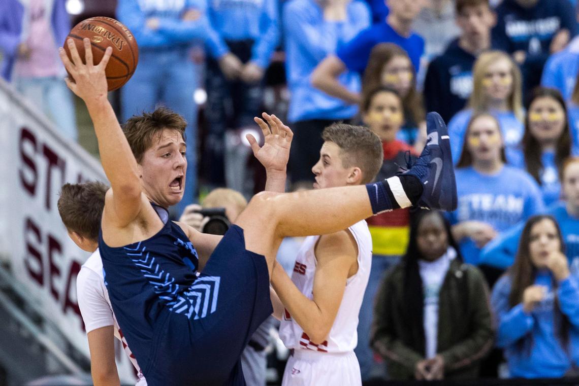 Ambrose forward Paul Yenor pulls down a rebound with a leg up on Grace’s Paysen Anderson in the 1A Division I boys basketball championship game Saturday at the Ford Idaho Center in Nampa.