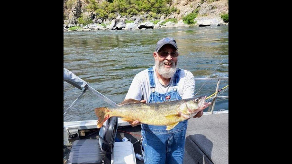 An angler holds a 25-inch walleye caught on the Snake River at the mouth of Rush Creek in Hells Canyon in August 2023.