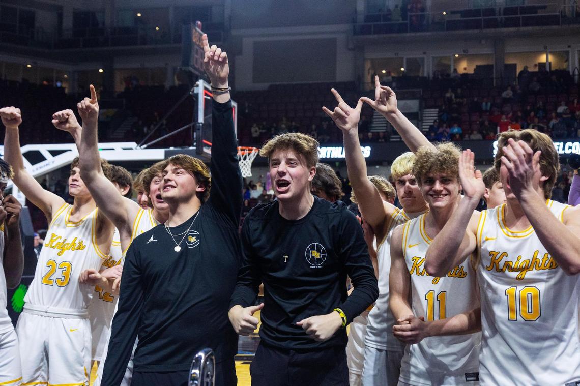 Bishop Kelly celebrates its 4A District Three boys basketball tournament championship win over Skyview.
