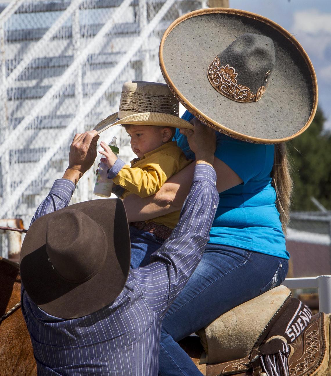 Miguel Muñoz straightens the hat of his son Gael, with mother Paloma Sanchez as the escaramuza team takes a break from a pre-performance practice in New Plymouth.