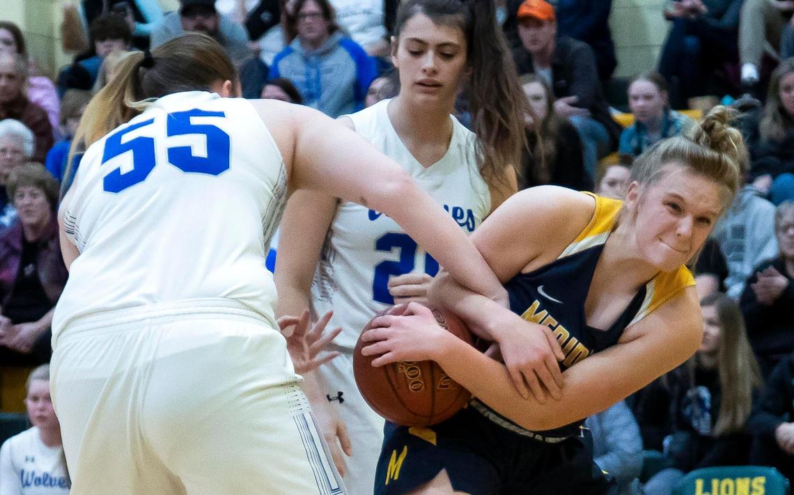 Meridian’s Taylor Bonning fights for a loose ball against Timberline on Feb. 8, 2020.