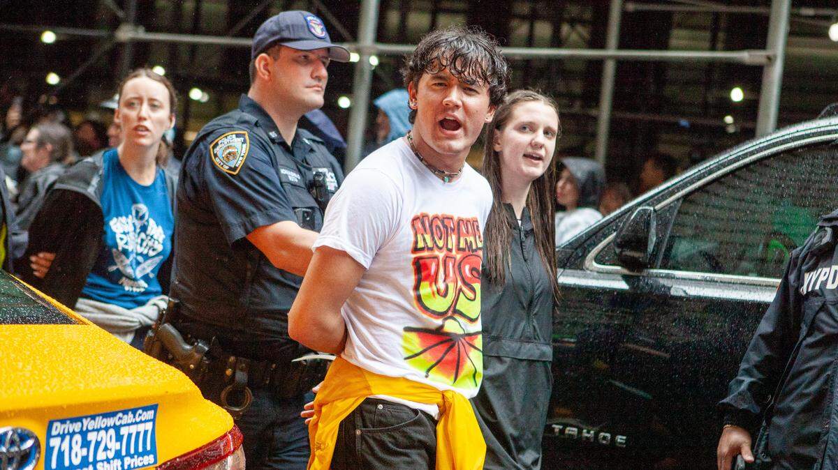 Boise School Board member Shiva Rajbhandari is led away by police after being arrested at a New York City climate protest on Monday.