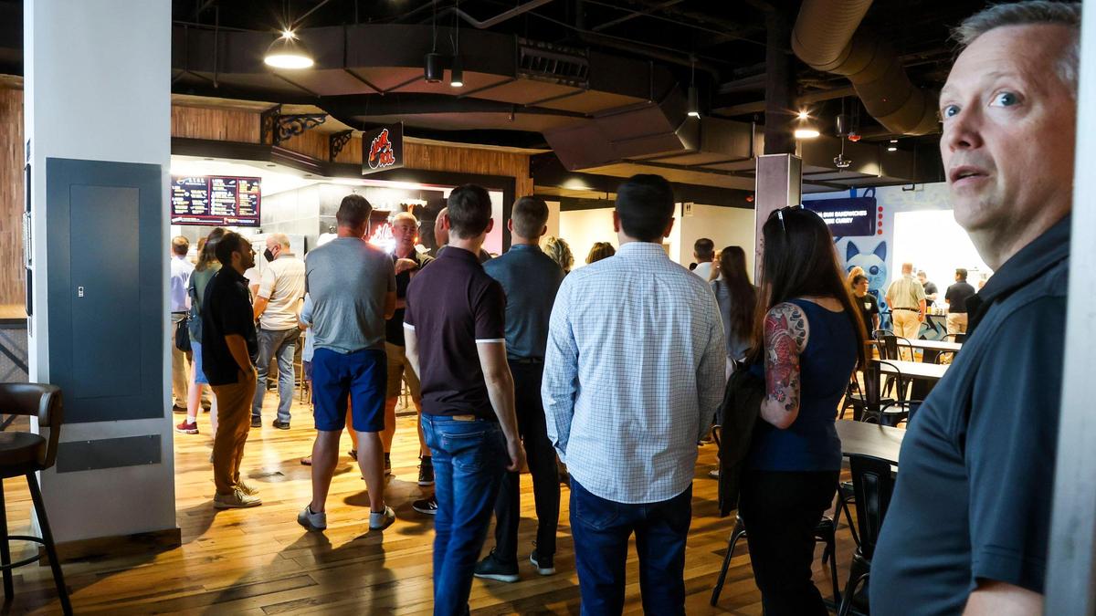 A line grows for one of many food options during the grand opening of the Warehouse Food Hall in downtown Boise.