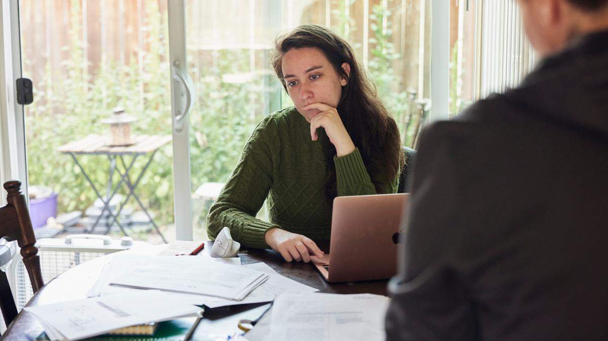 Emily Carter, left, and Kieria Krieger now live together in Portland, where their home is buried in documents from their yearslong fight with Cornerstone.