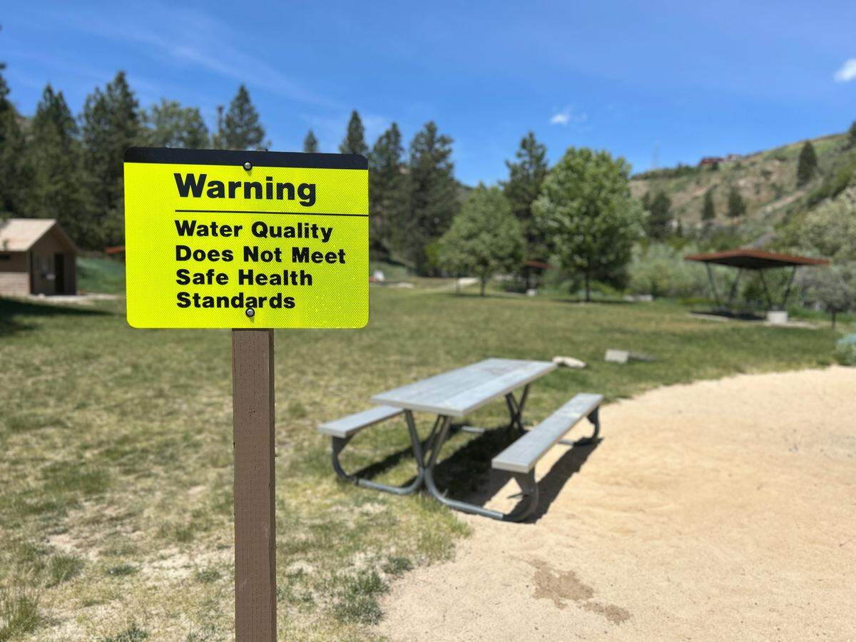 Officials posted warning signs at Robie Creek Park to let visitors know that it is not safe to swim.