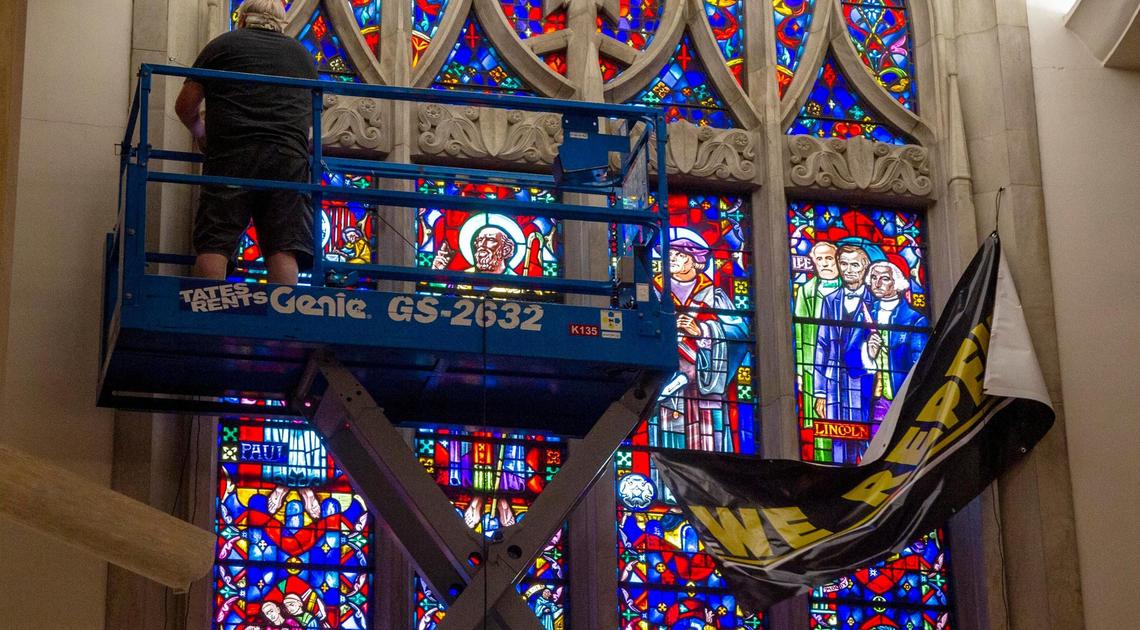 Staff at Cathedral of the Rockies place a “We Repent” banner in front of a stained-glass panel depicting Robert E. Lee standing with U.S. Presidents Abraham Lincoln and George Washington on Friday, June 12, 2020, at the Boise First United Methodist Church. The church plans to replace the image of Lee this summer.