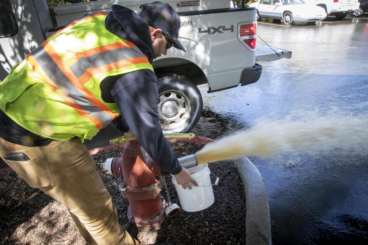 Suez Water Idaho utility worker Ryan Shipp monitors the water being flushed from a hydrant on the Boise Bench Wednesday, May 1, 2019.