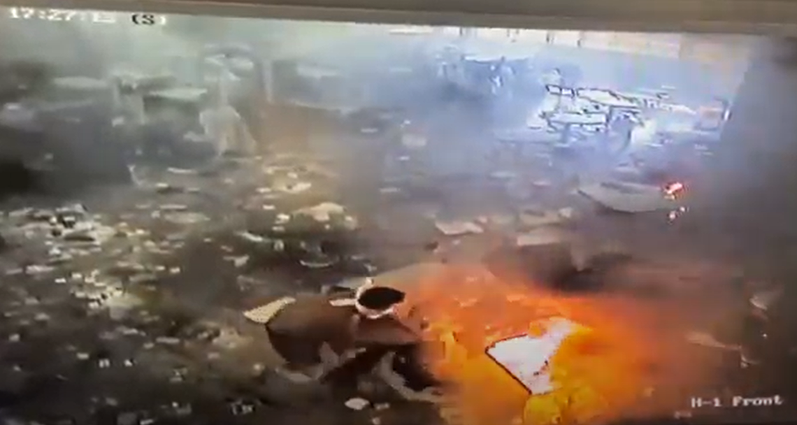 A man inside H-Block, Tier 1 of the Idaho State Correctional Center throws items onto an open fire during an incident inside the prison on April 10, 2021.