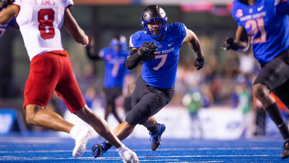 Boise State linebacker Ezekiel Noa takes off after intercepting a Fresno State pass. Noa had a big game to lead a strong defensive effort.