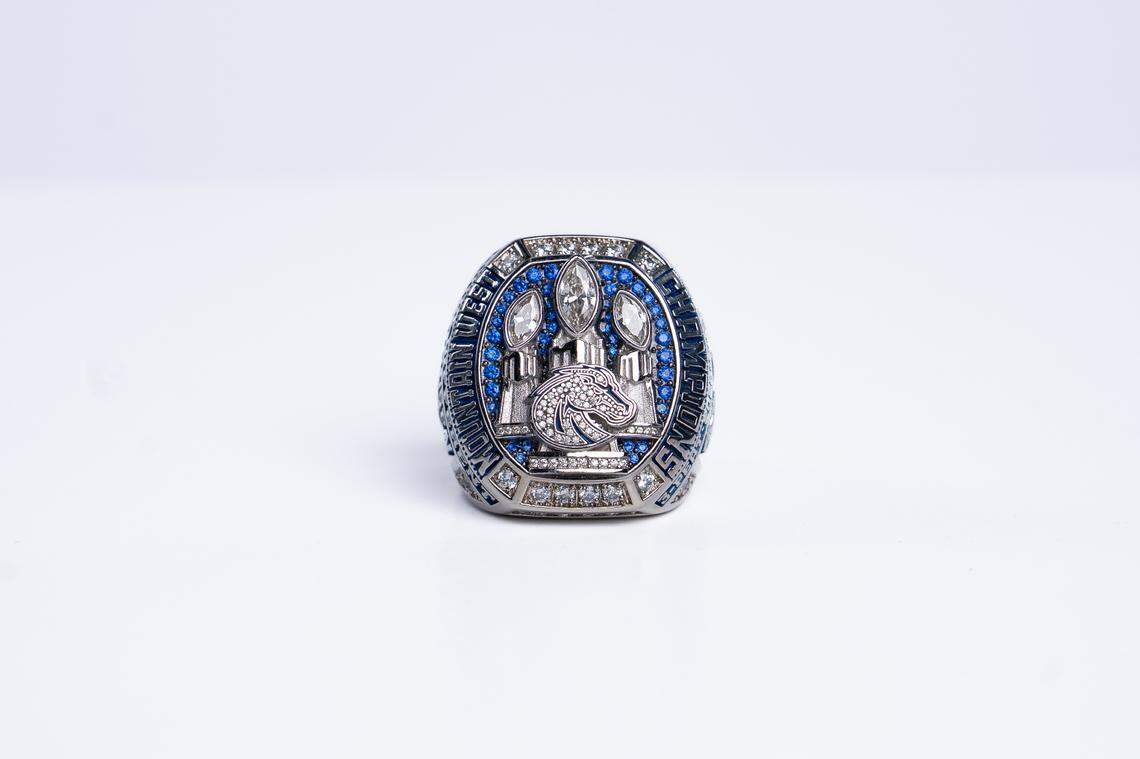 The three Mountain West trophies are all capped with a giant white diamond in place of the football on the top of the trophy.