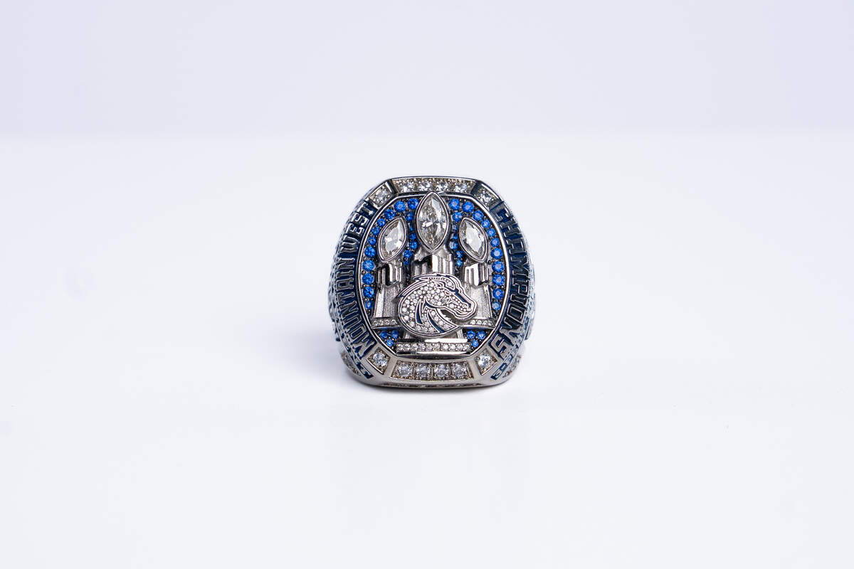 The three Mountain West trophies are all capped with a giant white diamond in place of the football on the top of the trophy.