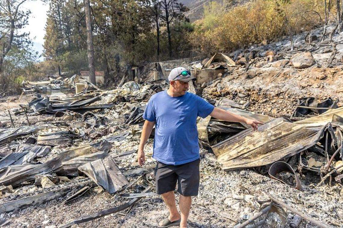 Joseph Phillips shows where different parts of his home once stood before the Gwen Fire near Lewiston tore through the area in July.