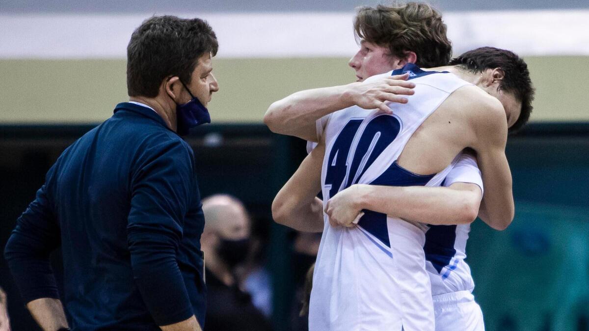 After both fouling out of the game, Riverstone seniors Nick Liebich (40) and Ethan Hunt hug at the end of their first state 1A Division I boys basketball championship run that ended in a 82-60 loss to Lapwai Friday, March 5, 2021 at Ford Idaho Center in Nampa. Head coach Steve Bowen congratulated his team on the surprise success of their season.
