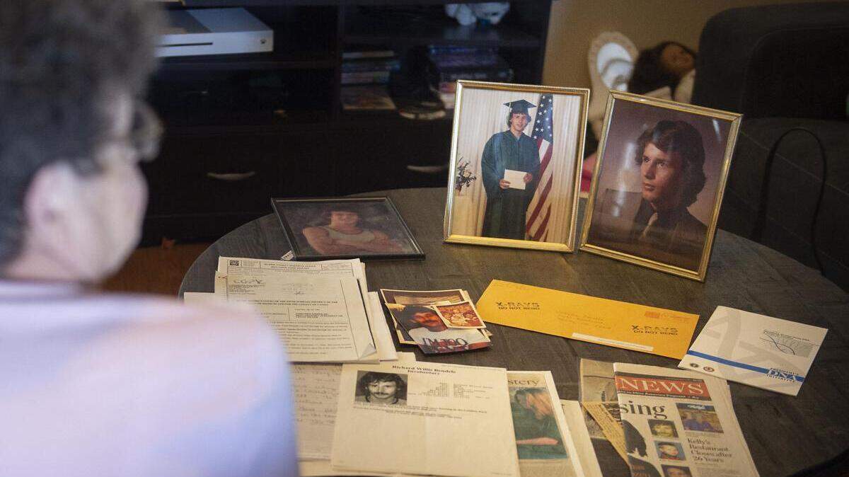 Looking at news clippings, flyers and photos, Sandra Bendele talks about her son, Richard Bendele, who was declared dead in 2003.