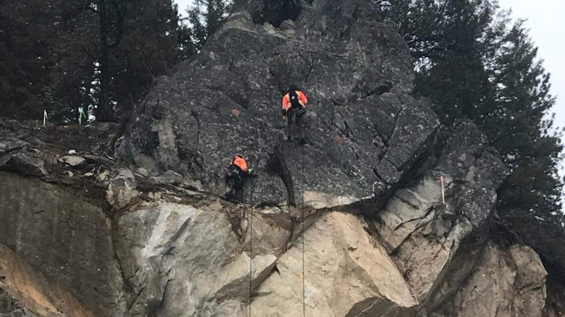 A geotechnical crew examines the rock above Idaho 55, which will reopen Wednesday morning.