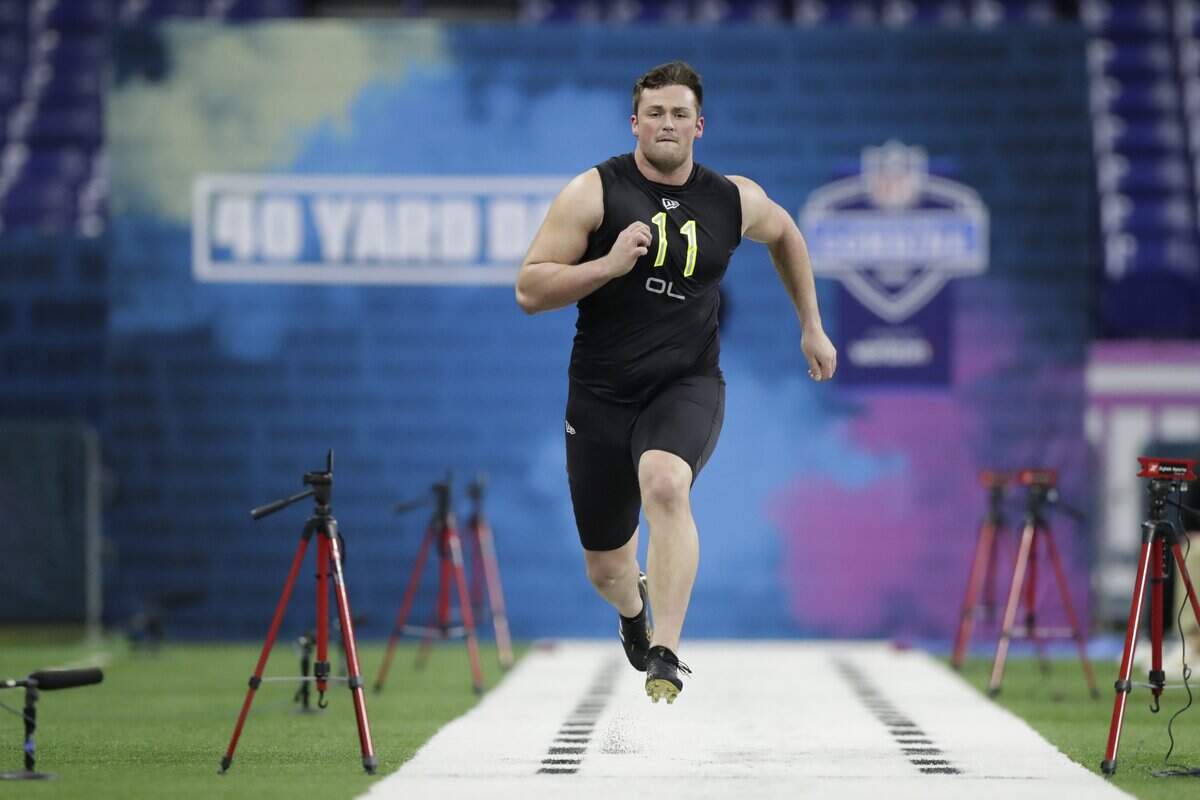 Boise State offensive lineman Ezra Cleveland runs the 40-yard dash at the NFL football scouting combine in Indianapolis, Friday, Feb. 28, 2020. (AP Photo/Michael Conroy)