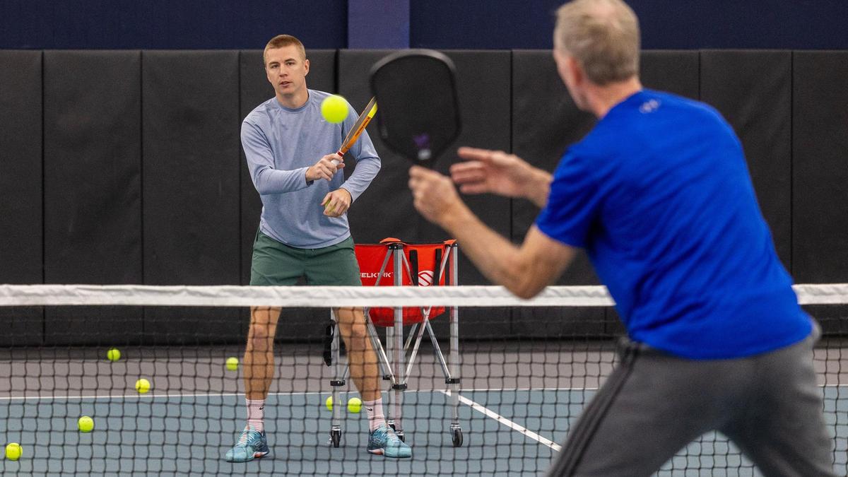 Pickleball pro Billy Buchhauser gives a lesson to Jake Conklin of Boise at The Flying Pickle. Buchhauser told the Statesman he was “looking for something to do” when he first tried the sport in college. “You play once or twice, and just get hooked,” Buchhauser said. Then, “You’re playing every day, and then every day turn into tournaments, and you’re obsessed.”