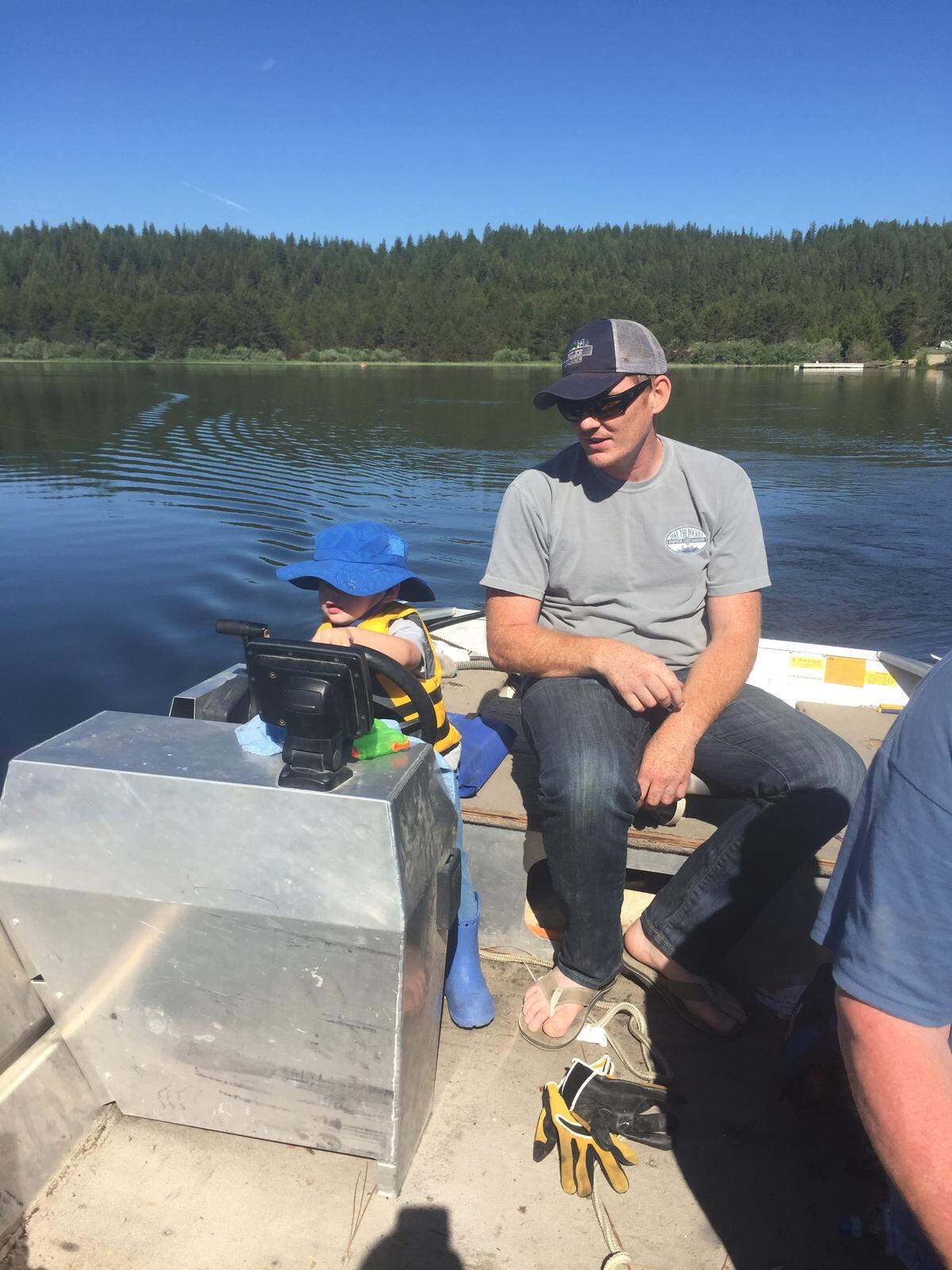 Horsethief Reservoir camp hosts Keith and Debbie Kinn enjoy the family atmosphere at the lake. This is their grandson, Hank, getting a boating lesson from his dad, Sean.