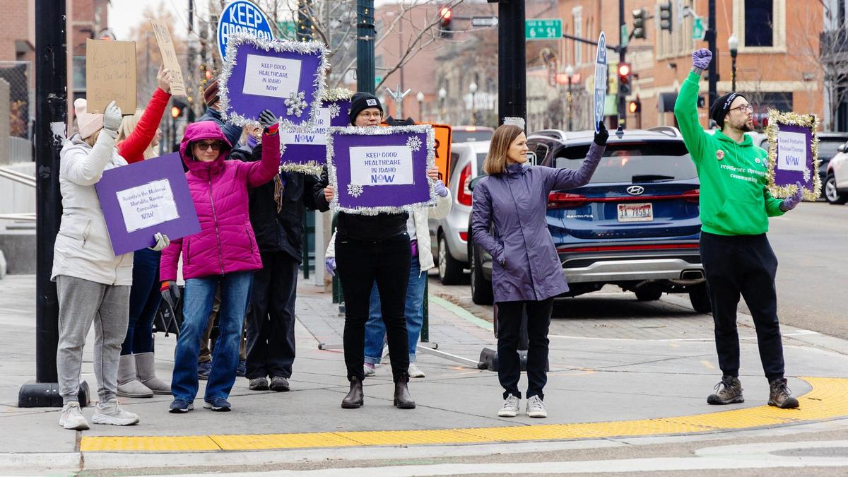 People march with the Southwest Idaho chapter of the National Organization for Women on Friday in downtown Boise to call attention to women’s health care issues.