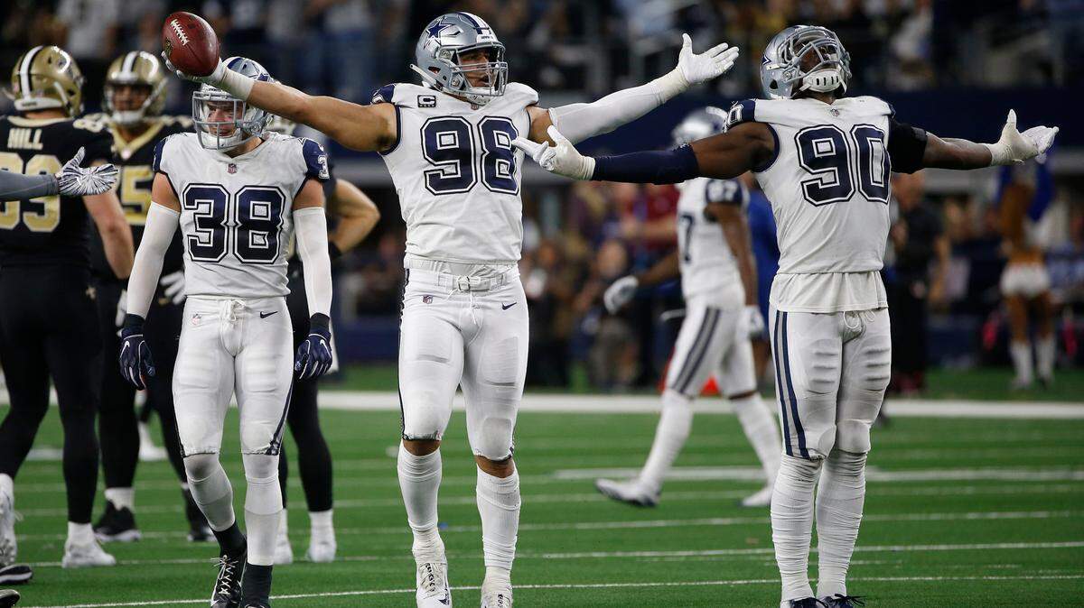 Dallas Cowboys defensive tackle Tyrone Crawford (98) and defensive end DeMarcus Lawrence (90) celebrate during the second half of their game against the New Orleans Saints in Arlington, Texas,on Nov. 29, 2018.