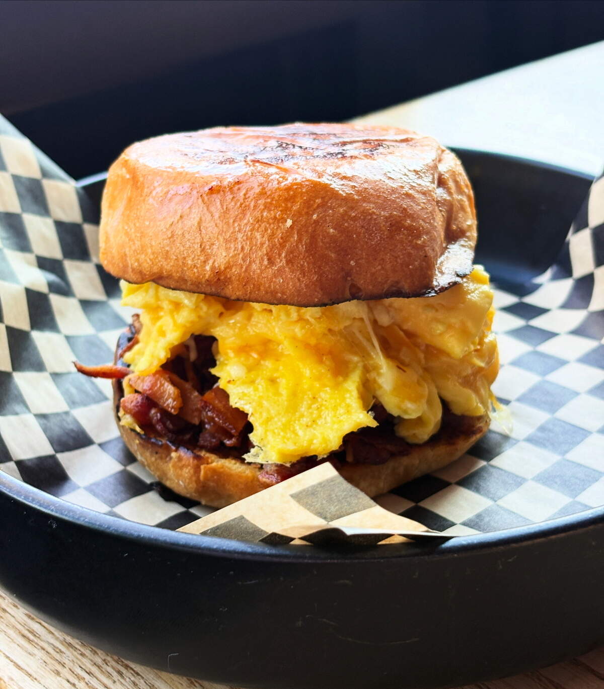 The Standard ($9.99) breakfast sandwich features bacon, egg and cheese stacked on a brioche bun.