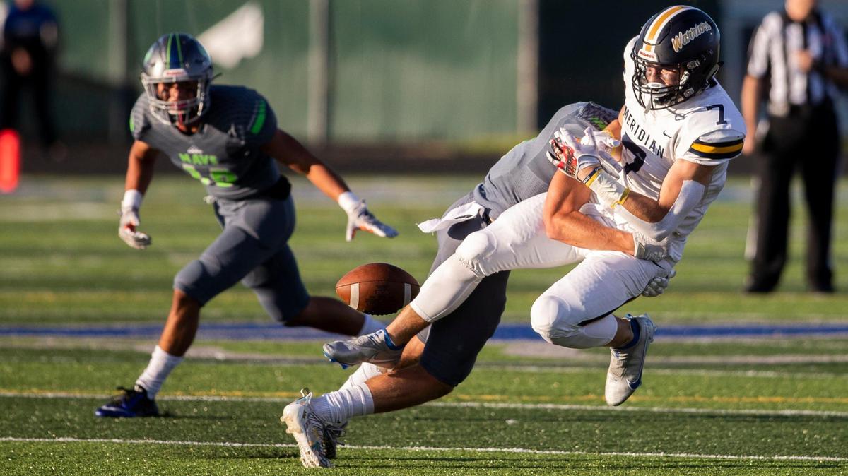 Mountain View defensive back Rylan Elliott separates the ball from Meridian’s Nathan Reynolds on Aug. 27. The Mavericks’ stout defense has them undefeated and ranked No. 2 in the state.