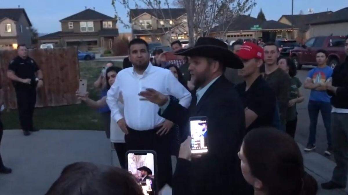 In this screen capture of a video posted by the Freedom Man PAC on YouTube, Ammon Bundy, center, and several other demonstrators protest in April outside the house of a Meridian police officer.