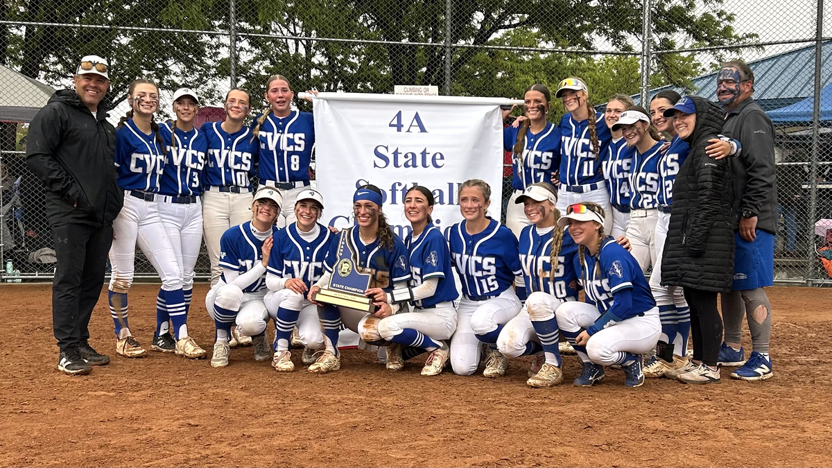 The Cole Valley Christian softball team poses with the championship banner after beating Kimberly 11-5 for the 4A state title Saturday at Skyview High in Nampa.