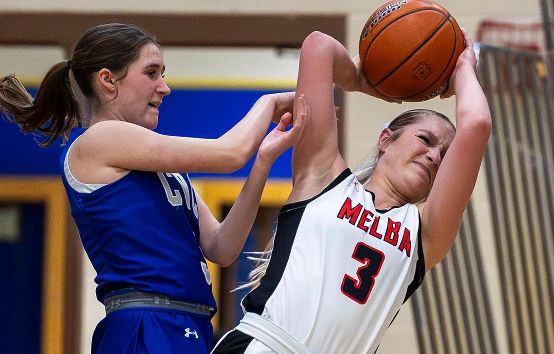 Melba forward Tariah Carter, right, battles for possession of the ball with Cole Valley Christian’s Amelia Anstrand in the 2A District Three girls basketball championship Feb. 6 at Caldwell High.