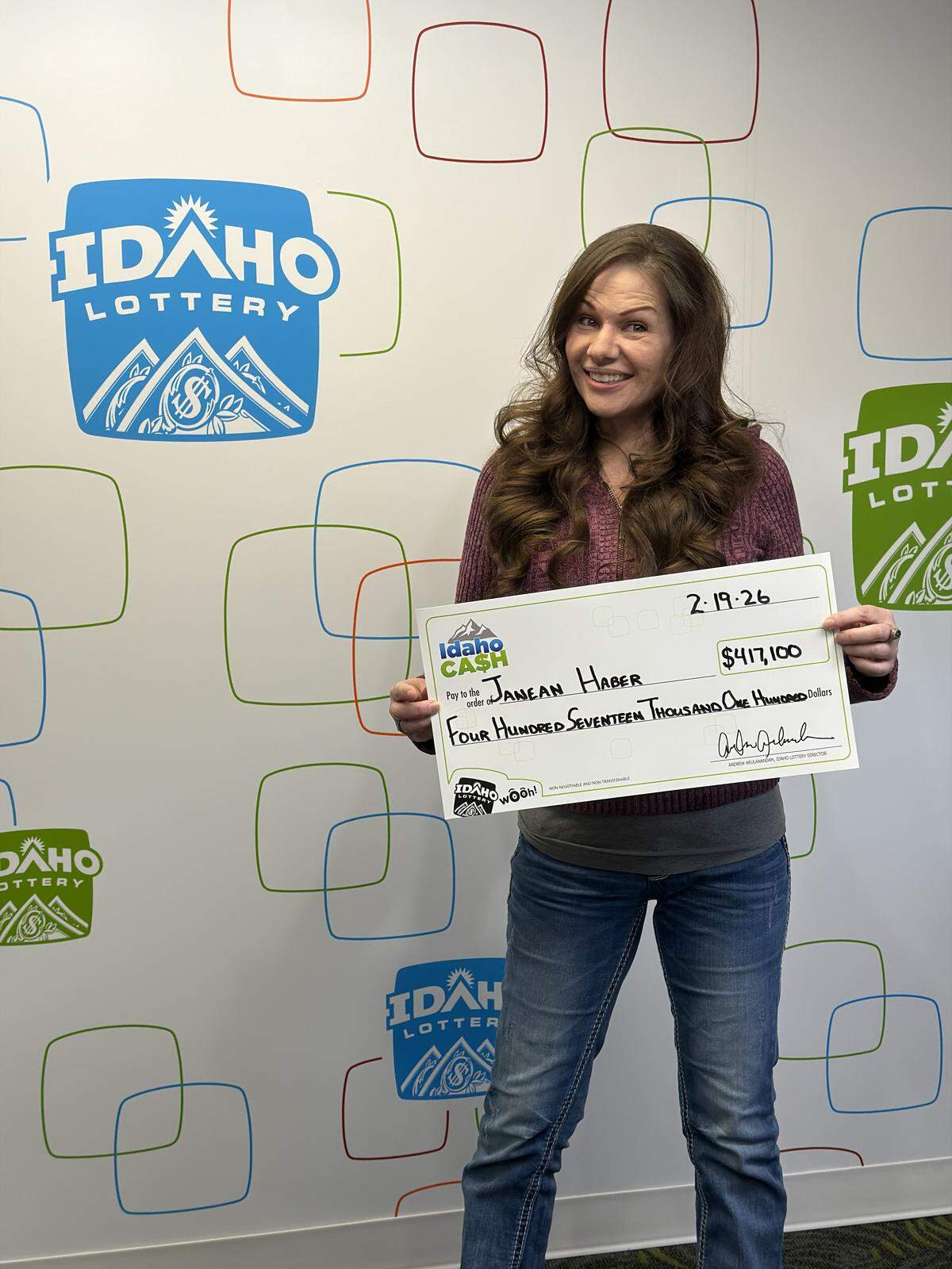 Janean Haber is shown holding a check for $417,100 in the Idaho Lottery office.