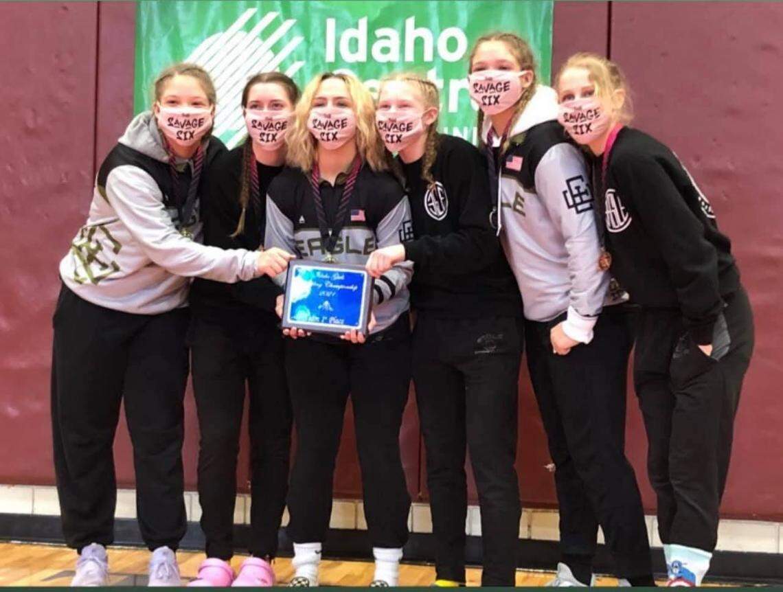 The Eagle girls wrestling team poses with their championship trophy from the unofficial girls wrestling state tournament last year in Pocatello. Idaho will host its first official girls state tournament this week.