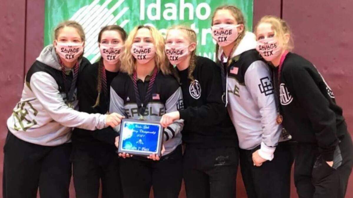 The Eagle High girls wrestling team poses with their championship trophy from the unofficial girls wrestling state tournament Saturday in Pocatello. Idaho will begin sponsoring an official girls state tournament next year.
