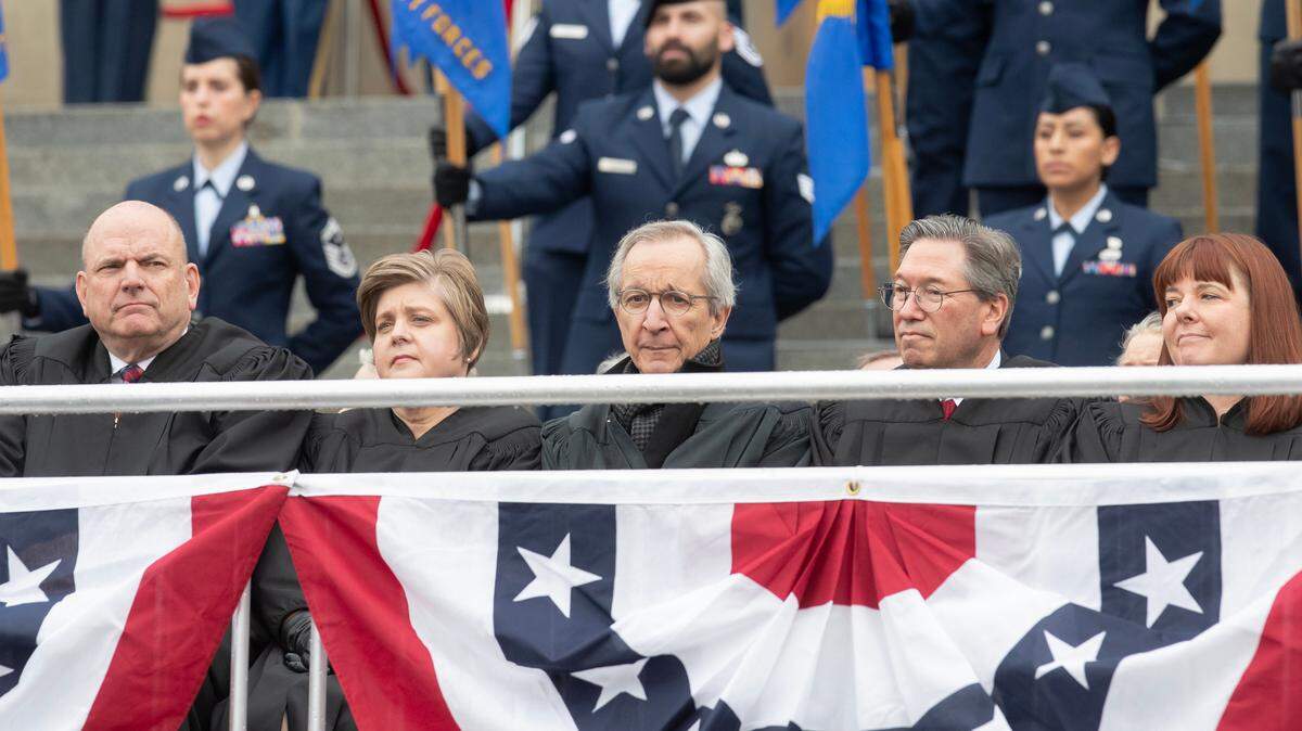 Idaho Supreme Court justices are seated at the public inauguration ceremony for Gov. Brad Little and other newly ordained state officials. Idaho Chief Justice G. Richard Bevan, left, asked lawmakers for protection amid a “dangerous” political climate Wednesday.