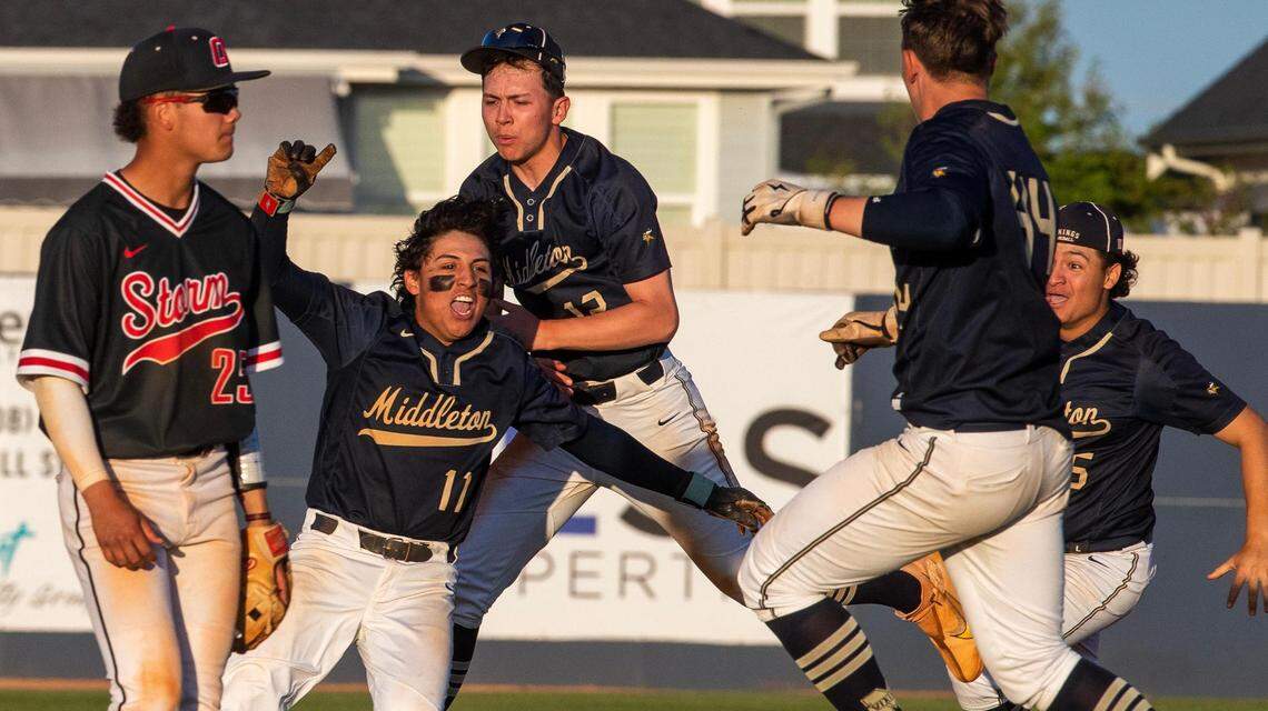 Middleton mobs senior Isaiah Anzaldua (11) after a walk-off hit to win the 5A District Three baseball championship in May. The Vikings are asking to stay in Idaho’s top classification in football and baseball.