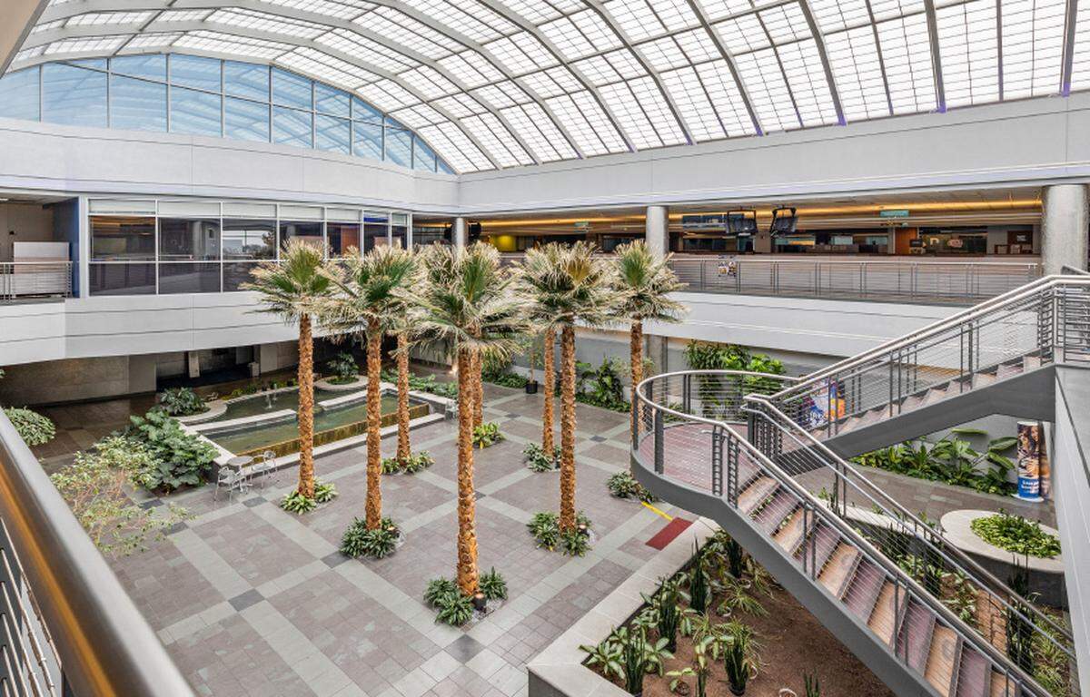 The new headquarters includes palm trees and a water fountain in the middle of its main interior courtyard, shown here in center and center left.