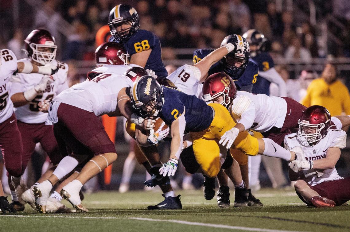 Meridian running back Kross Antonnacchi lunges forward for extra yards Friday against Rigby in the 5A state semifinals.
