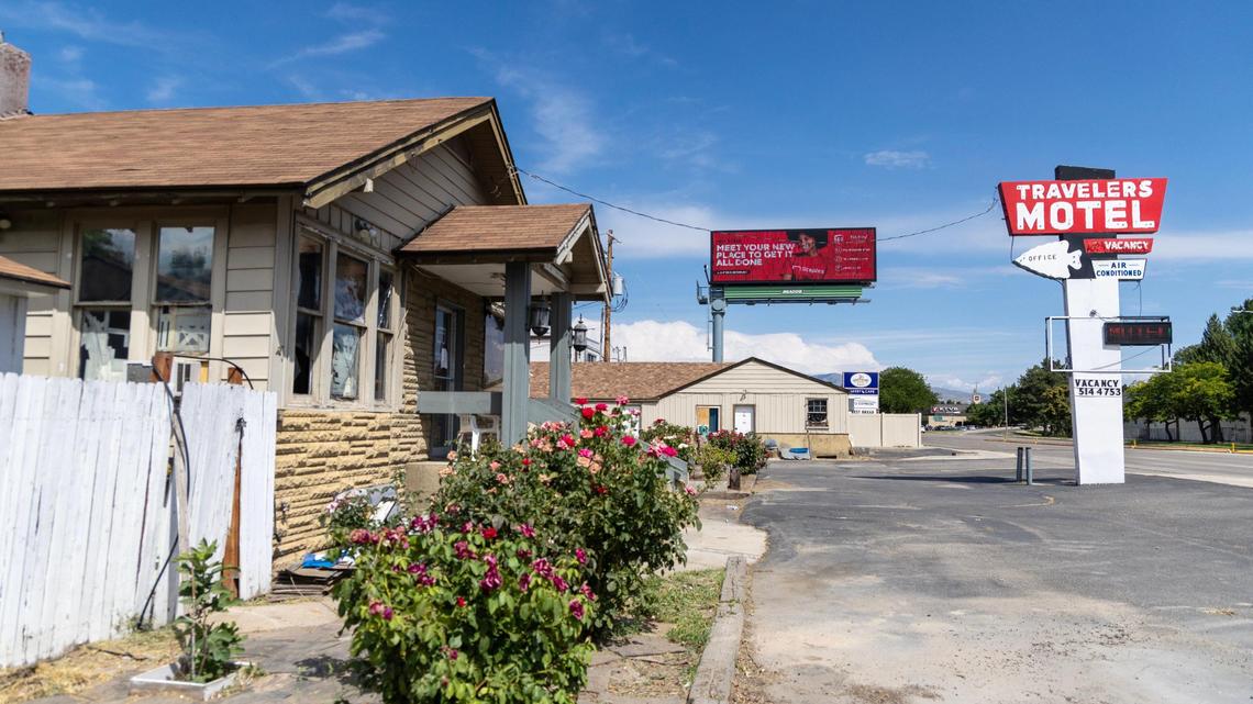 The front of the office building at the Travelers Motel has broken windows that are covered with duct tape.