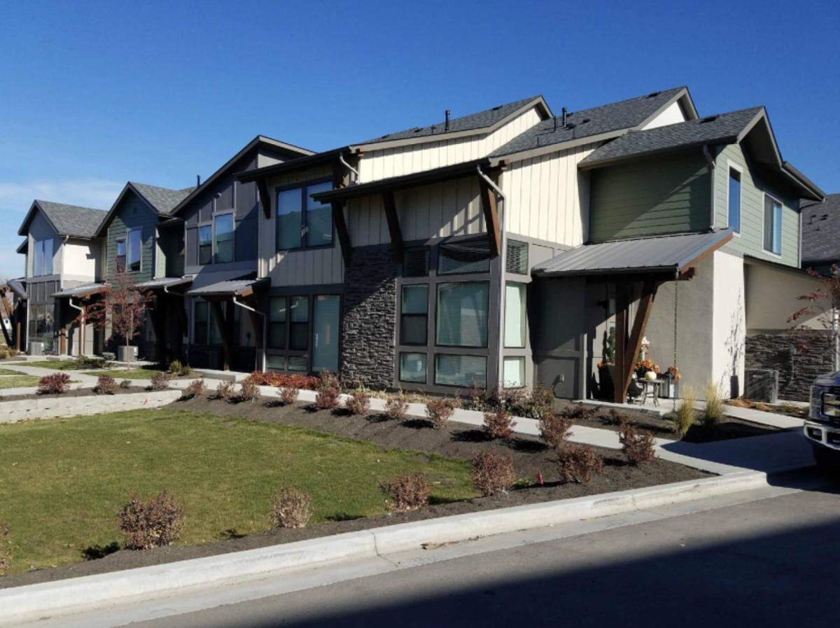 The Pura Vida subdivision would include 157 houses, including townhouses like these that would face a central courtyard. Cars would access the garages via a back alley.