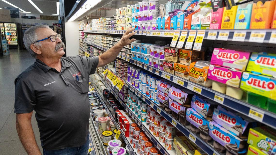 Charlie Long, manager of the Ridley’s Family Market in Kuna, faces yogurt on shelves, Wednesday, July 3, 2024. Long is retiring after decades working in the grocery business.