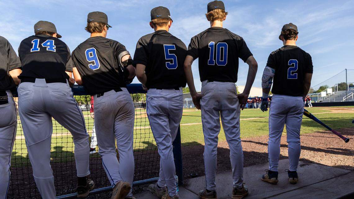 Eli Parker, right, waits for his chance at bat with teammates in Timberline's dugout. He's the team's designated hitter.