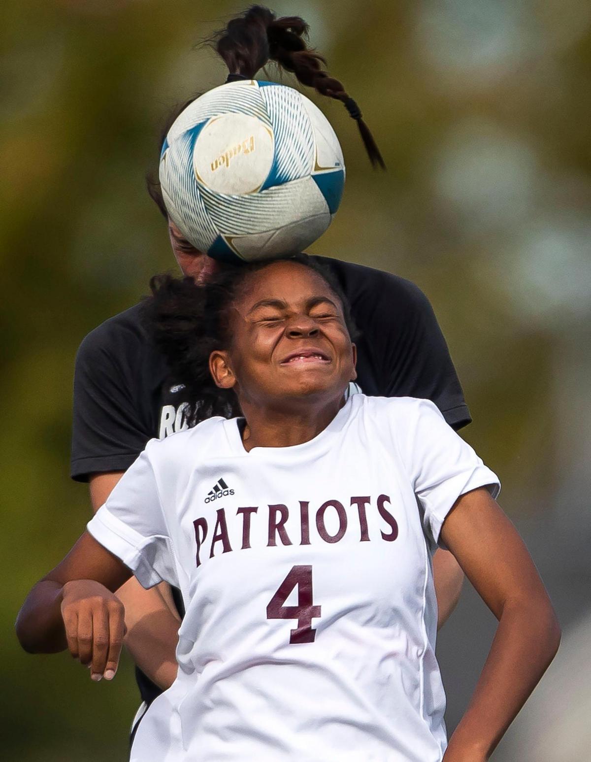 Centennial forward Asia Lawyer connects on a header in front of Rocky Mountain’s Jada Torpey the first round of the 5A girls soccer state tournament.